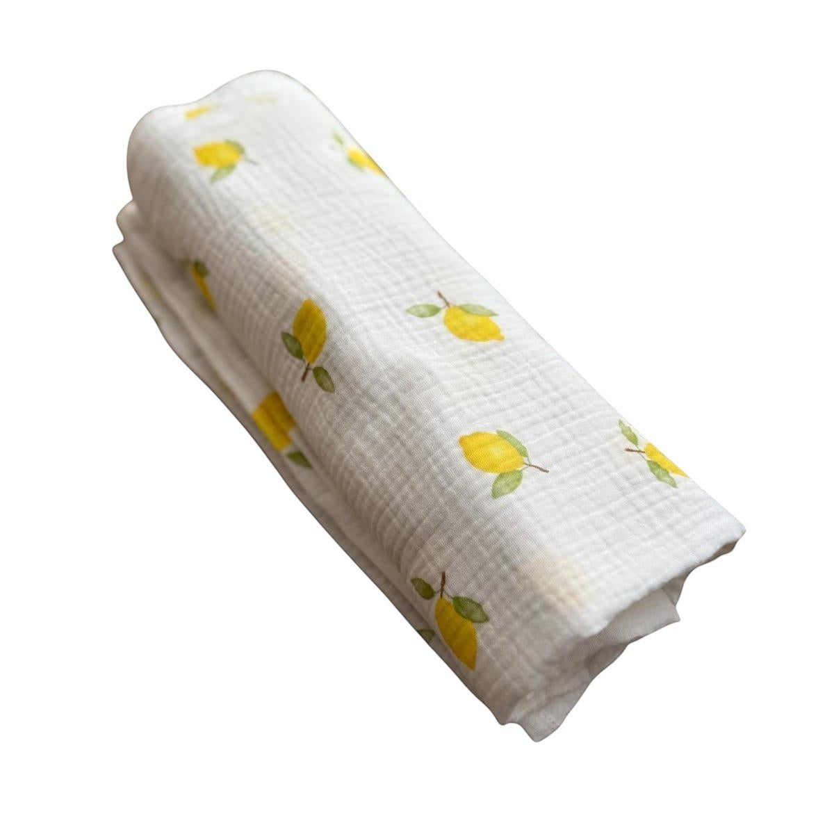 Baby NaturHere maxi muslin swaddle blanket with a white background and a yellow lemon print. Made of 100% cotton.