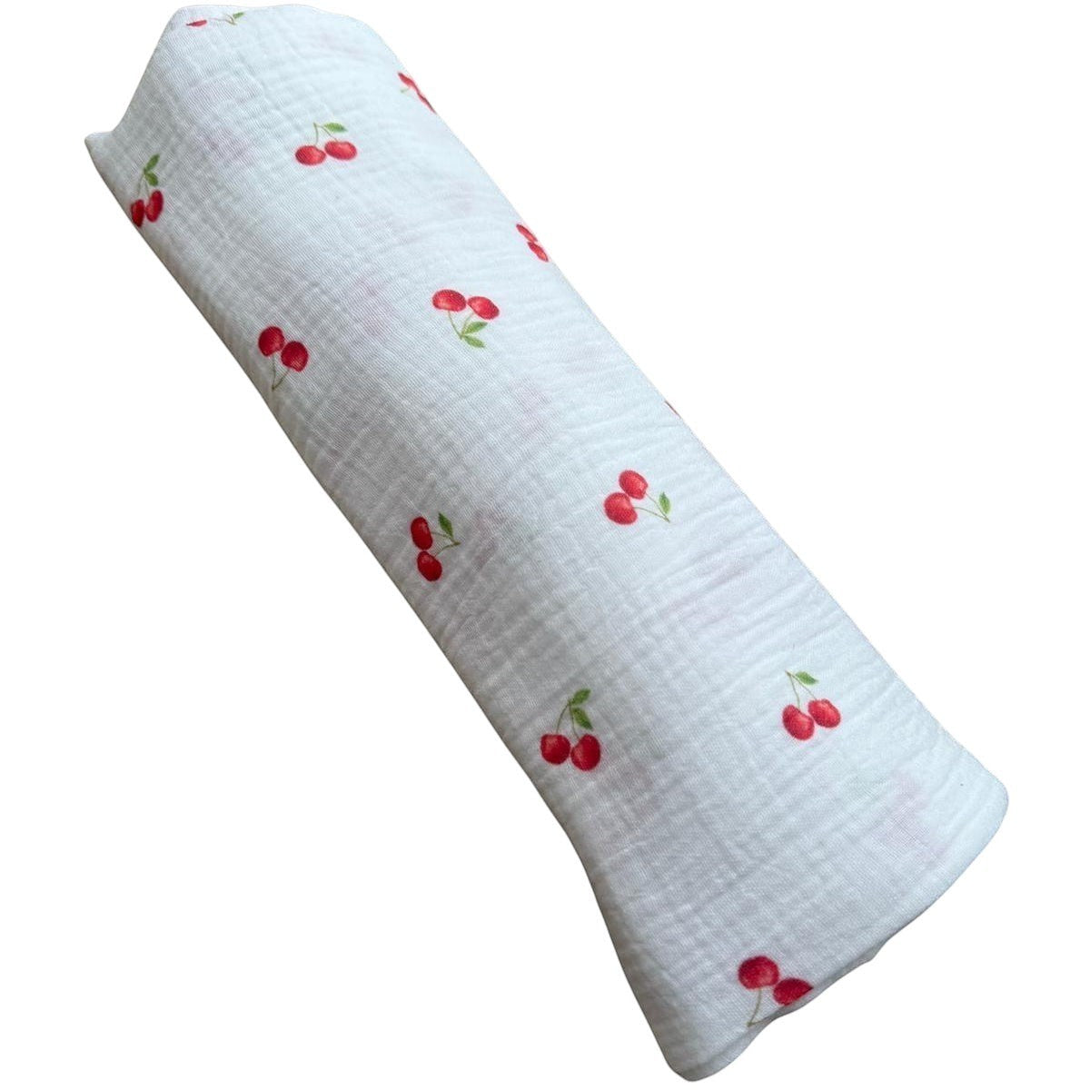 Baby Natur MAXI tetra muslin swaddle blanket with a white background and red cherry print. Made of 100% breathable cotton.