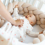 Baby Natur beige braided crib bumper made of soft, natural materials for a safe and cozy sleep environment.