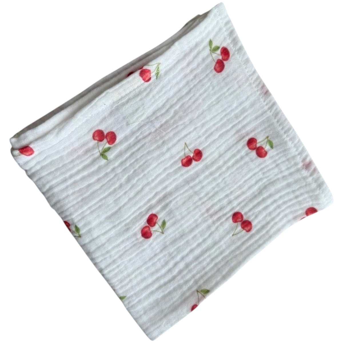 Baby Natur white muslin cloth with a red cherry print. Made from 100% cotton, perfect for babies.