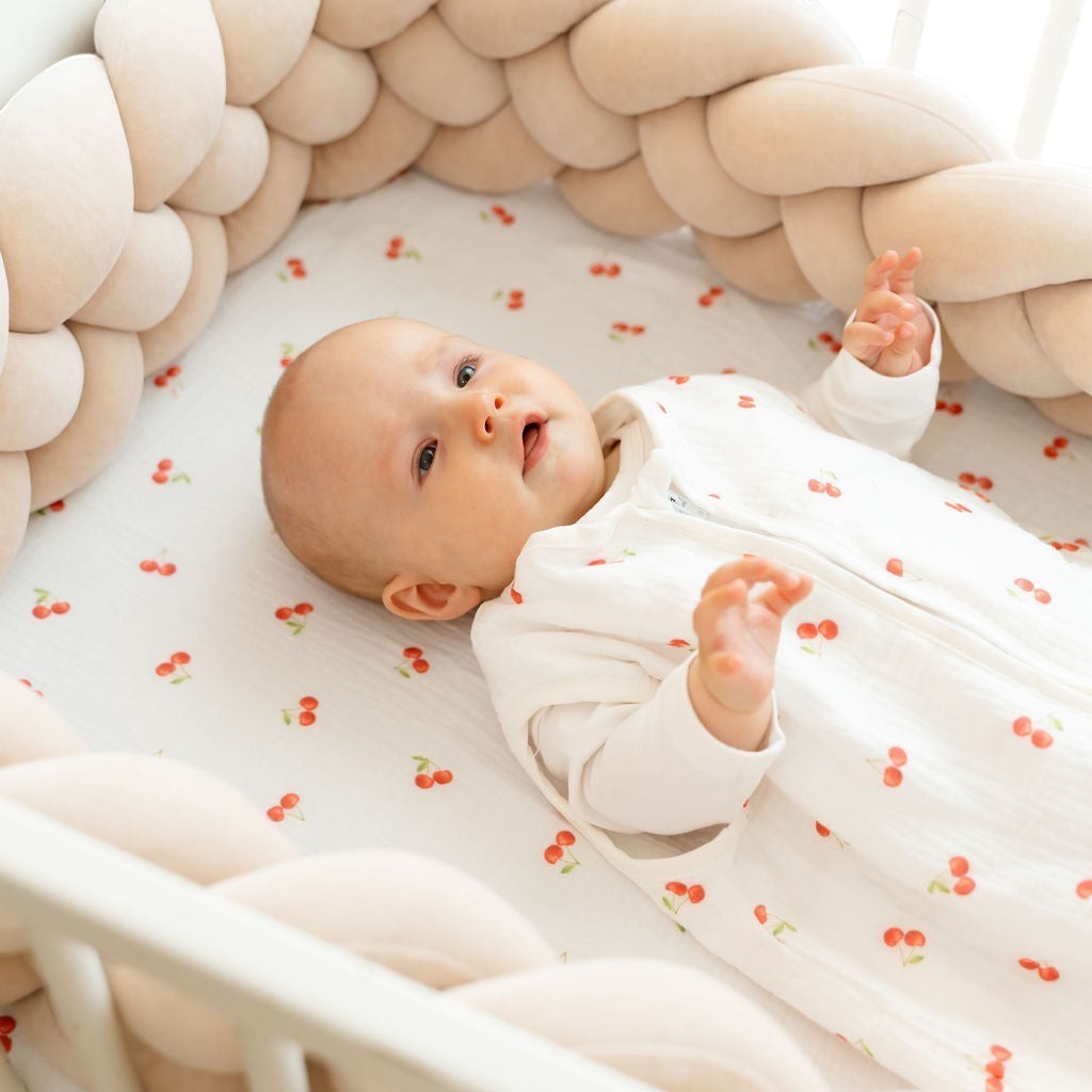 Baby Natur white sleeveless sleeping bag with red cherry print, made of soft, breathable cotton. For safe, comfortable sleep.