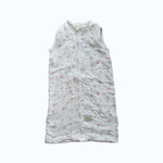 Baby Natur sleeveless sleeping bag with a delicate floral print in pink and yellow on white muslin fabric. Zipper closure.