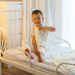 Baby Natur white muslin sleeping bag with yellow lemon print, short sleeves, and zipper closure. For kids.