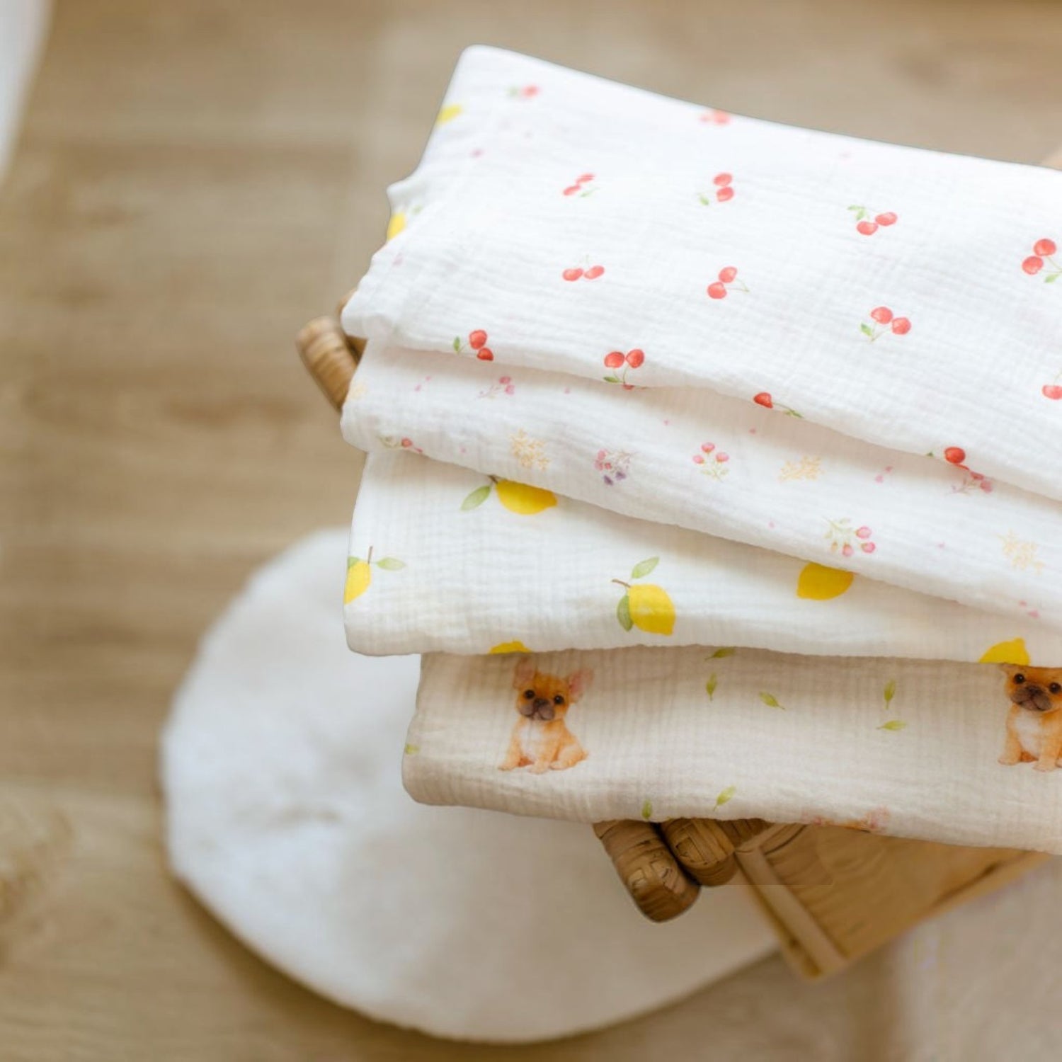 Baby Natur 100% cotton muslin cloths with cherry, lemon, and French bulldog prints. Soft, breathable, and washable.