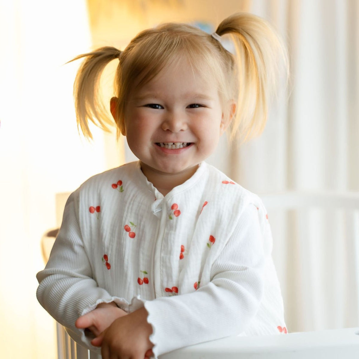 Baby Natur white 100% tetra muslin sleep sack with cherry print and scalloped cuffs. For babies.