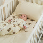 Baby Natur cream sleeping bag with teddy bear print, sleeveless design, made from soft, breathable materials for safe sleep.