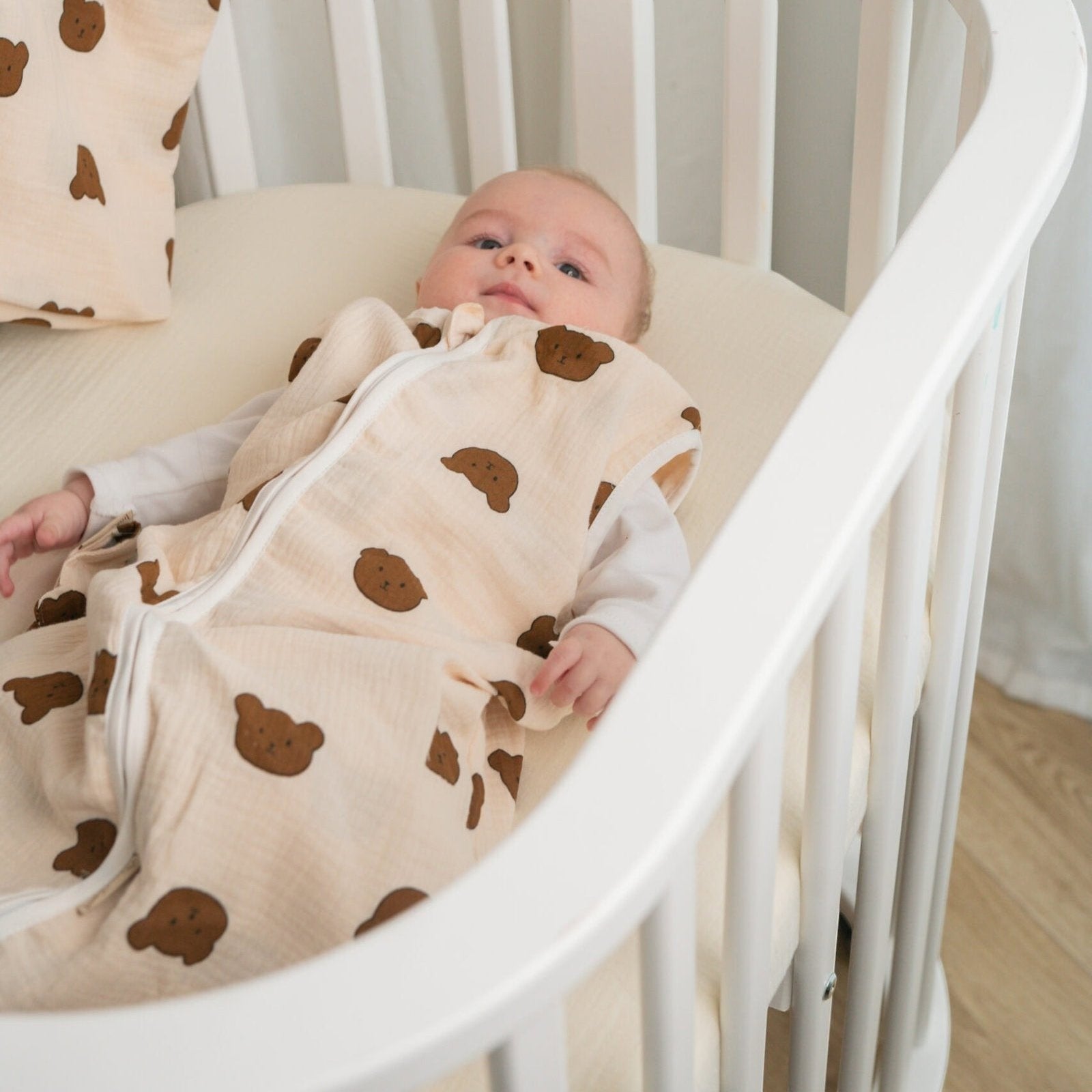 Baby Natur sleeveless sleeping bag in cream with brown bear print. Made from soft, breathable cotton for safe sleep.