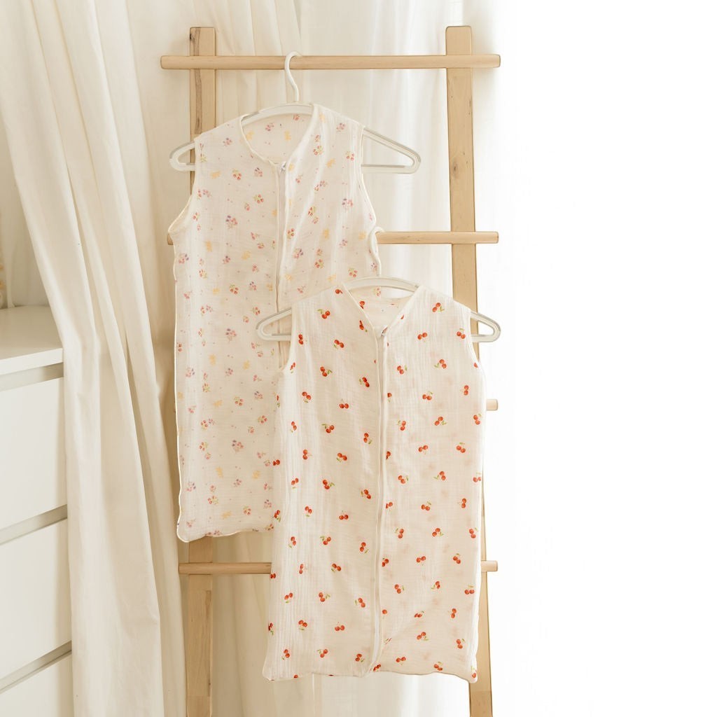 Baby Natur sleeveless sleeping bags in cream with cherry and floral prints. Made from soft, natural materials.