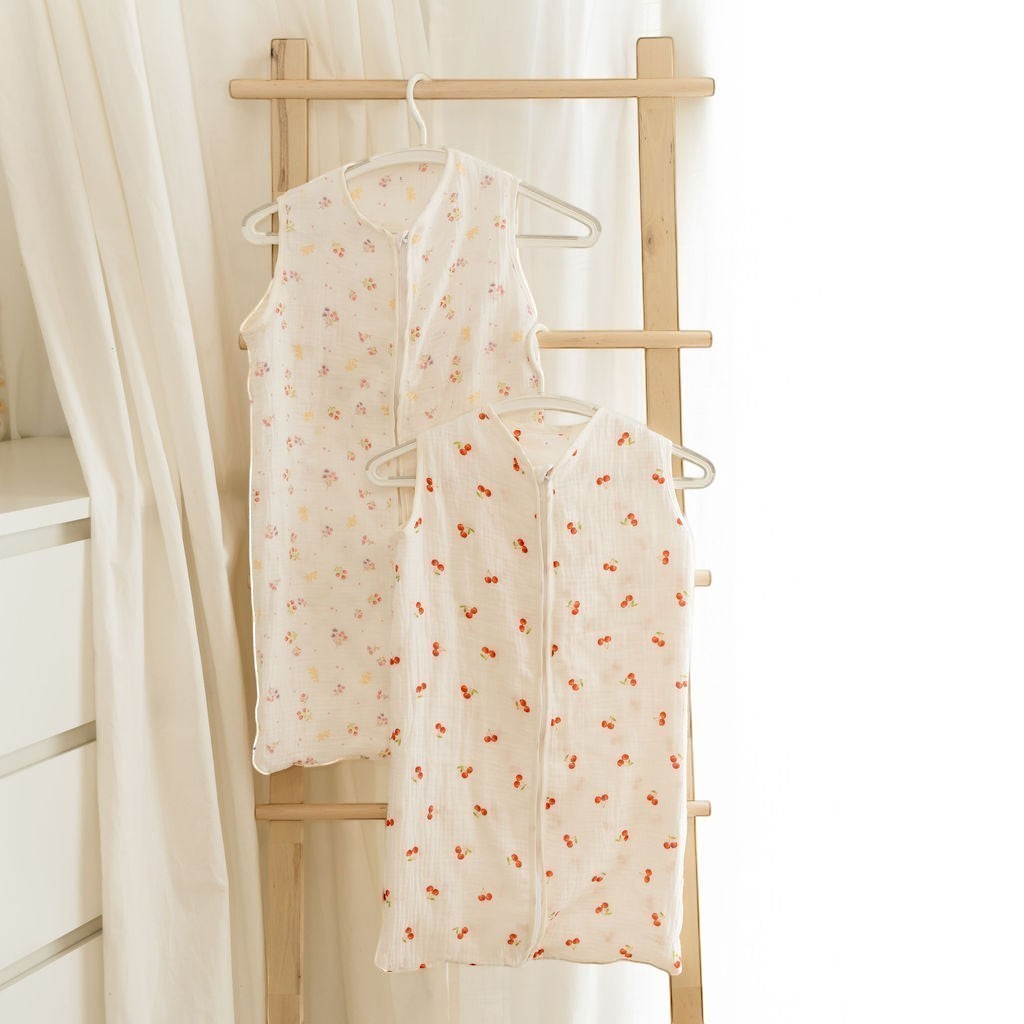Baby Natur sleeveless sleeping bags in cream with cherry and floral prints. Made from soft, breathable cotton.