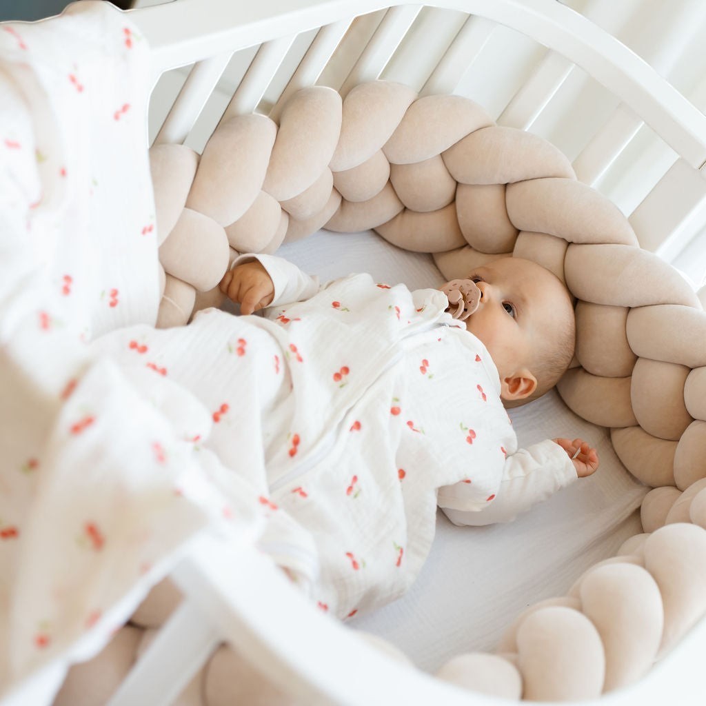 Baby Natur sleeveless sleeping bag in white with cherry print, made of soft cotton, for safe and comfortable sleep.