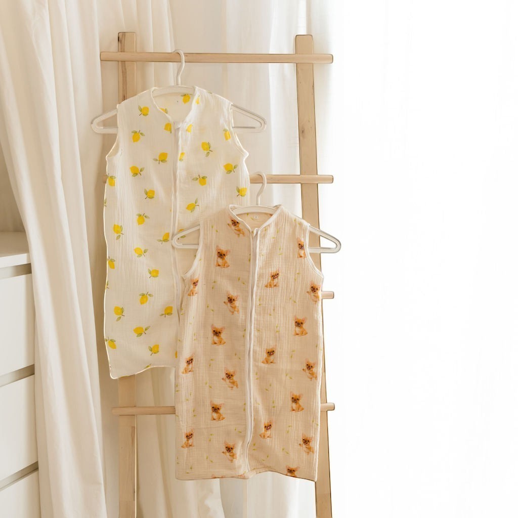 Baby Natur sleeveless sleeping bags in lemon and dog prints. Made from soft, breathable cotton for safe and comfortable sleep.