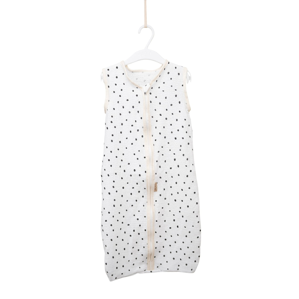 Baby Natur white sleeveless sleeping bag with black polka dots, made of soft, breathable cotton. Features a front zipper.