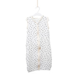 Baby Natur white sleeveless sleeping bag with black polka dots, made of soft, breathable cotton. Features a front zipper.