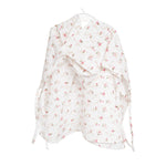Baby Natur white muslin poncho with pink floral print and hood. Ties at the sides.