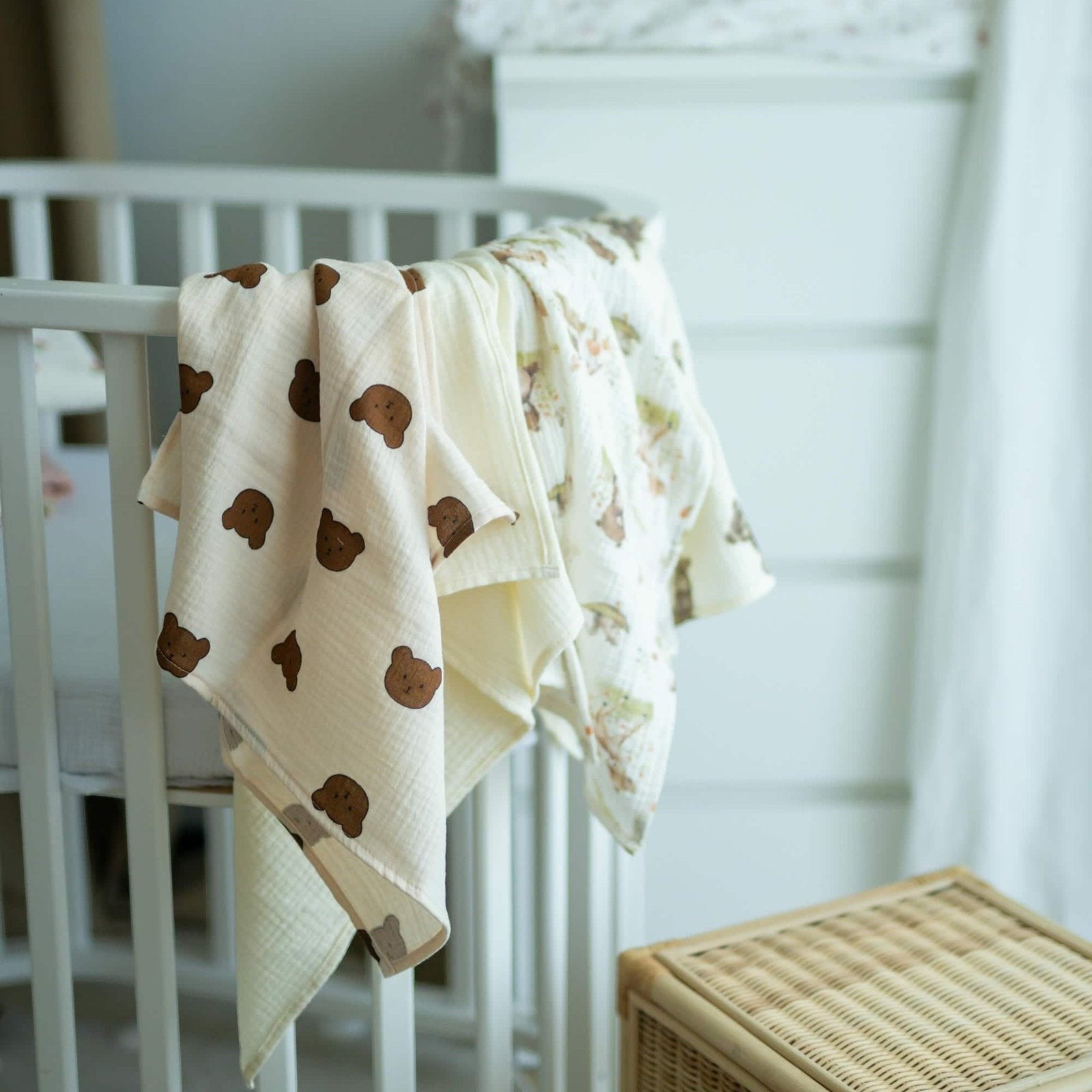 Baby NaturHere 100% cotton muslin swaddle blanket with brown teddy bear print. Soft, absorbent, and washable.